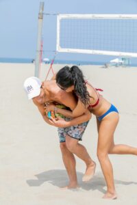 A joyful moment of friends playing beach volleyball on a sunny summer day, showcasing fun and energy.
